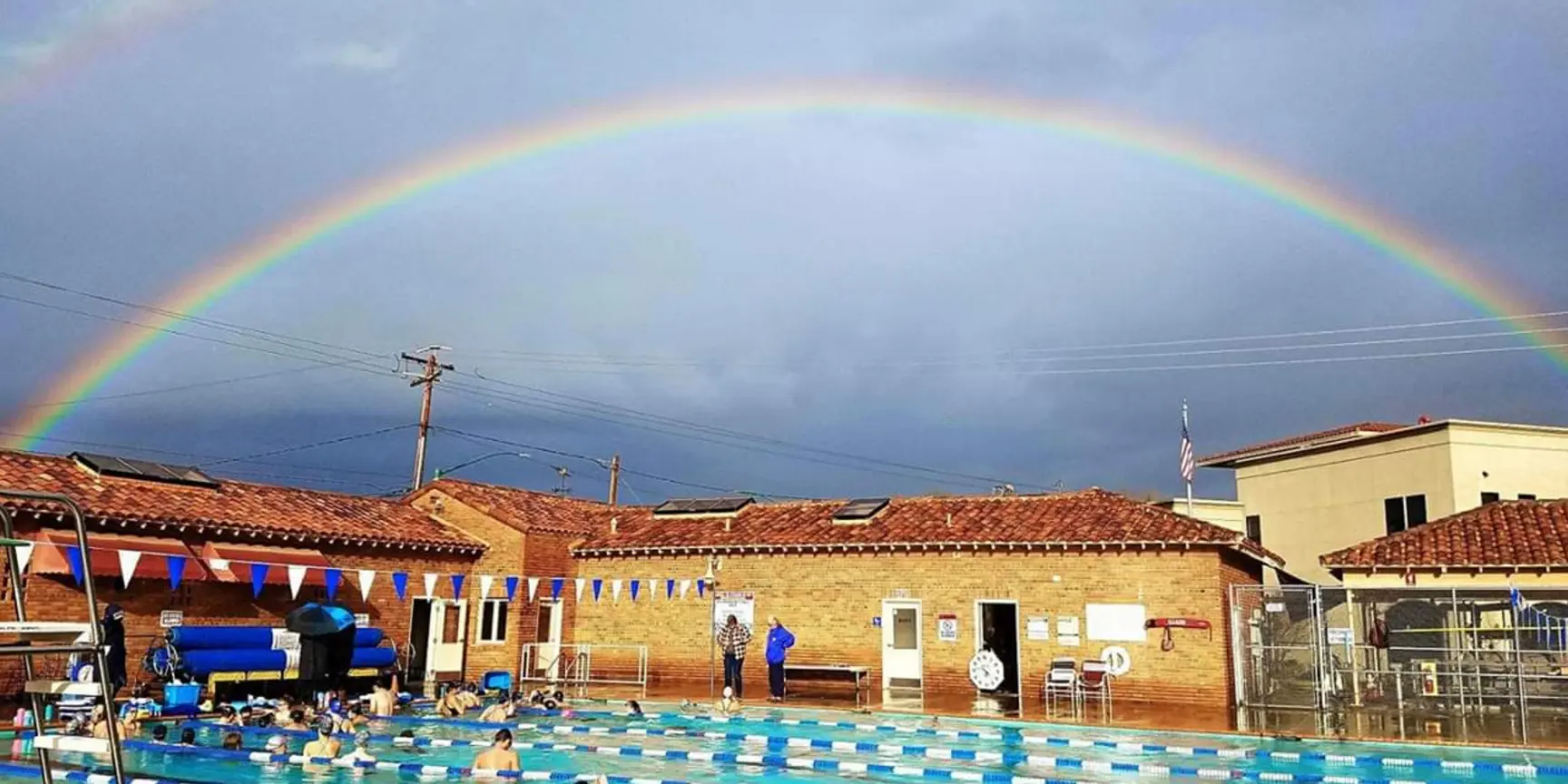 "Pool with rainbow in sky"