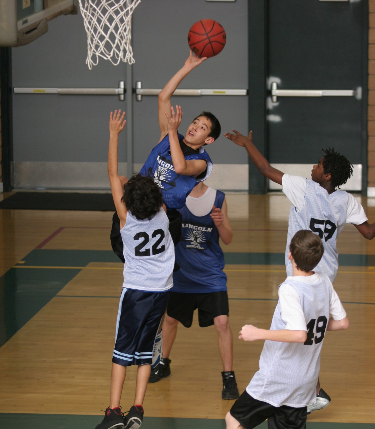 "Youth Basketball Player Shooting a Layup"