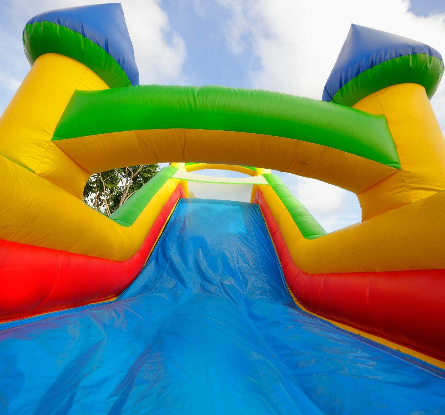 "Blue, yellow, green and red castle bounce house"